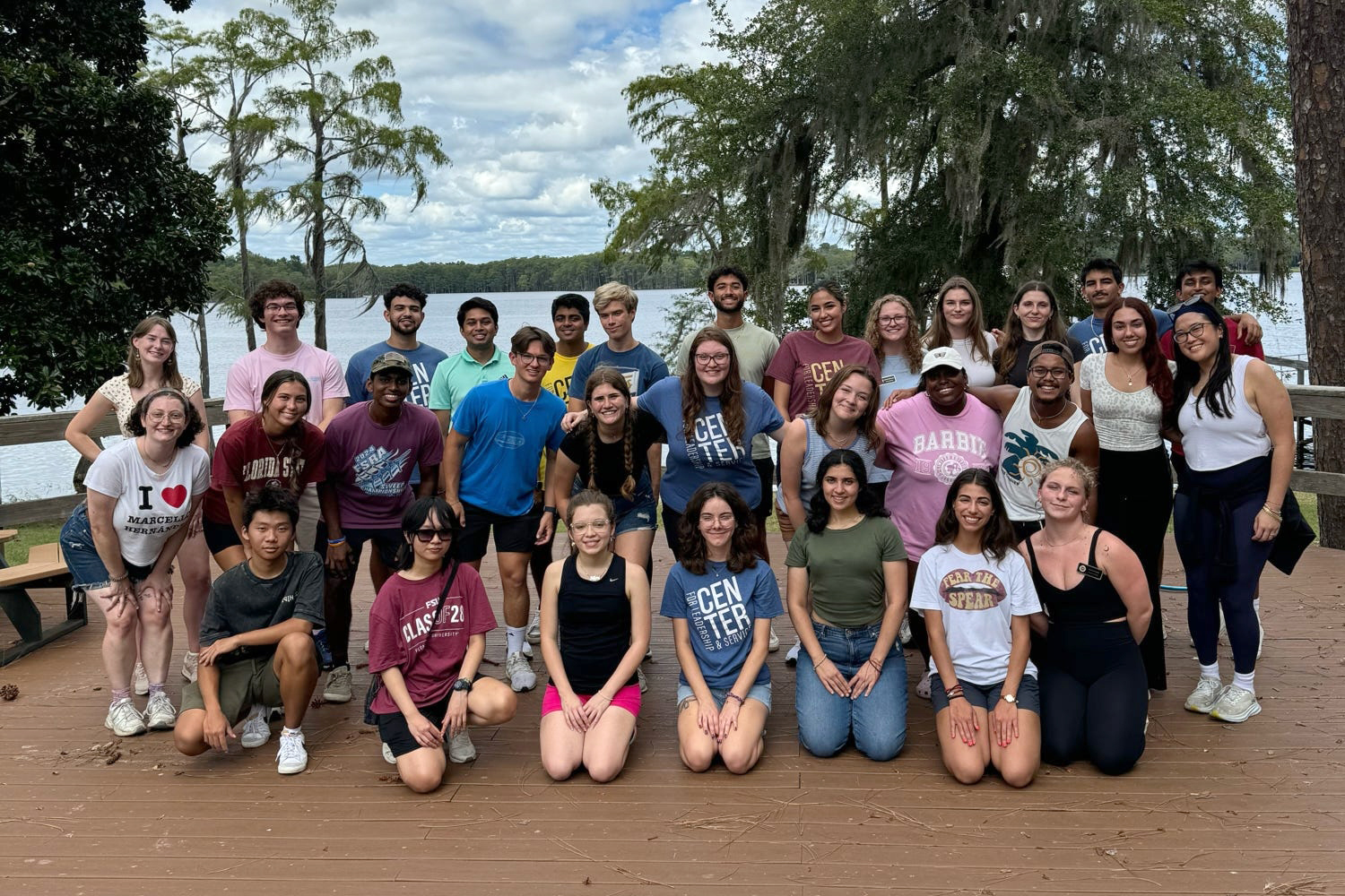 "Service Scholars pose for a group photo with Lake Bradford in the background"