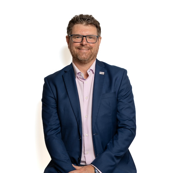 "Headshot of Eddie Fordham in business attire"