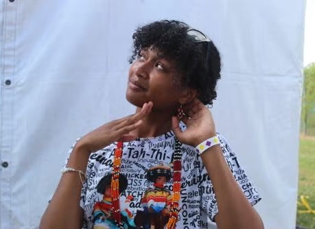 Student showing off beadwork earrings purchased at the celebration.