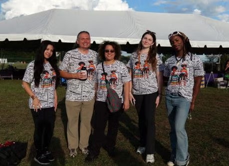 Volunteers pose at the American Indigenous Art Celebration.