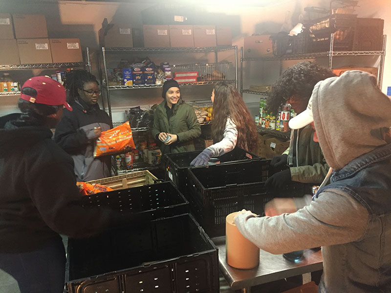 Students sorting items in the pantry.