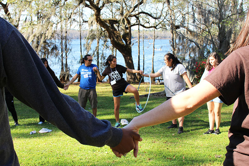 LOGIC participants hand-in-hand completing a group exercise