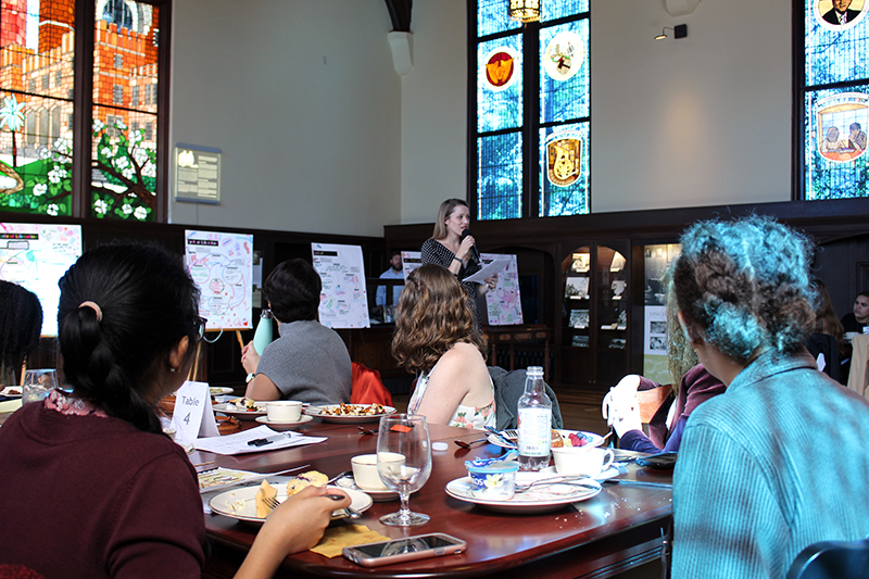 WLI participants enjoying a meal and watching a presentation