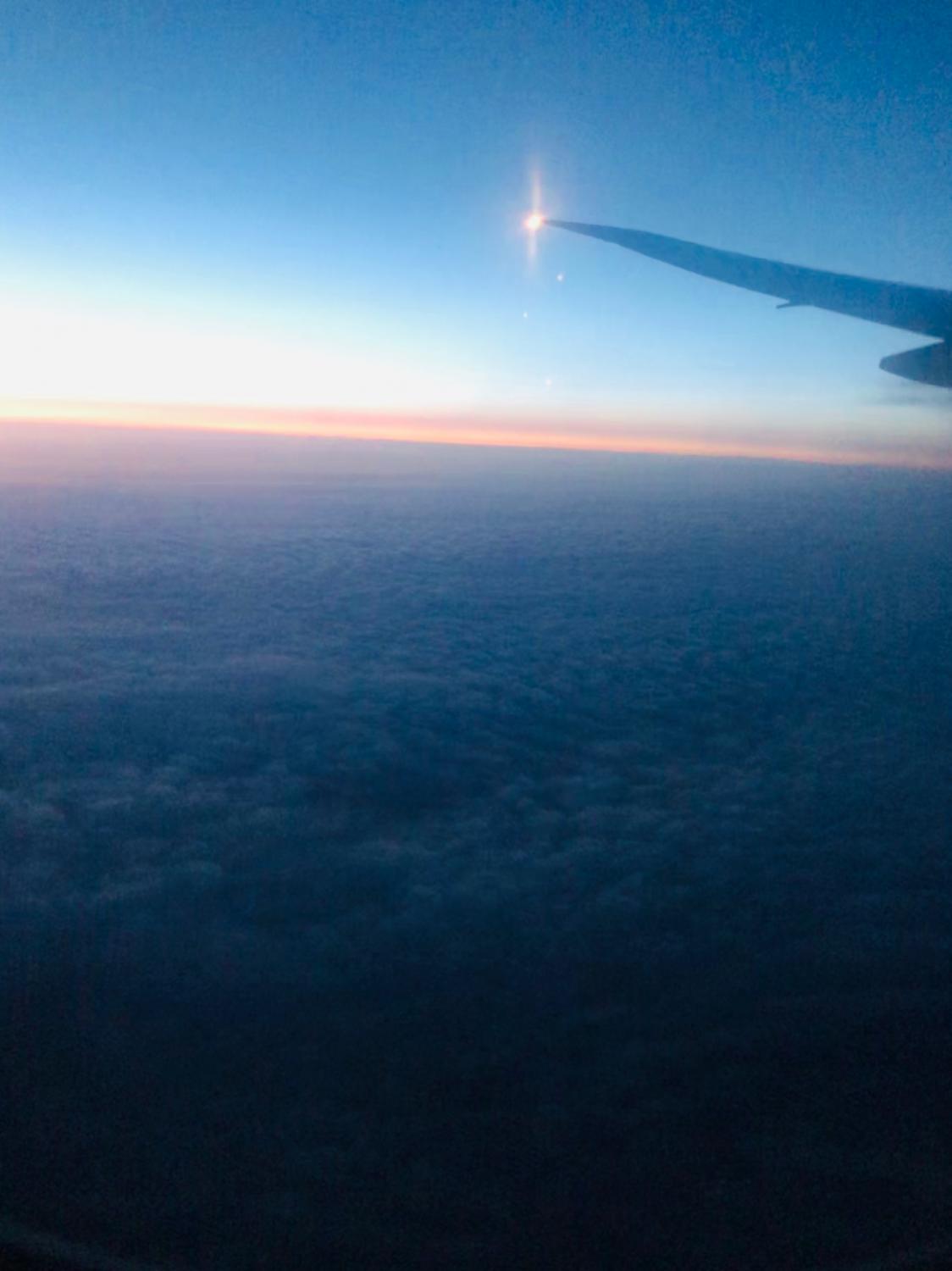 Image: Plane wing over clouds at sunset. The view from my flight out of Orlando to my connection in Dubai