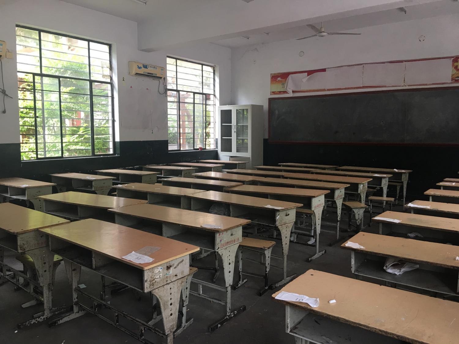 Rows of desks line a classroom in the best primary school in the county where Min conducted interviews. 